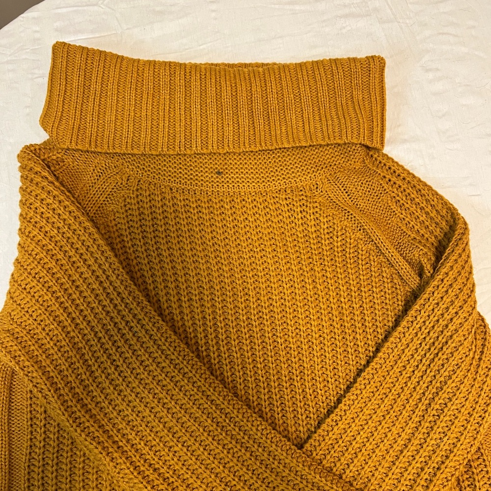 Orange sweater with wide turtle neck.